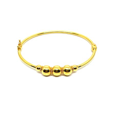 a 21k gold bangle with a clip lock. comfort use. a simple and minimalist design with a ball. design.